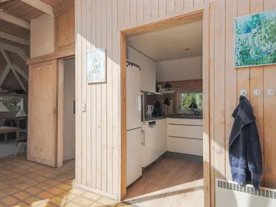 an open door into a kitchen with a refrigerator and a counter at Holiday Home Roulf - 1-1km from the sea by Interhome in Fjerritslev
