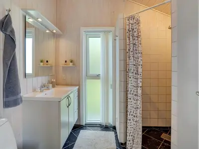a bathroom with a sink and a shower at Holiday Home Gothfred - 1km from the sea by Interhome in Fjerritslev