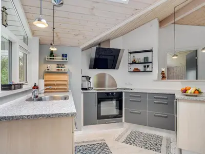 a kitchen with gray cabinets and a sink at Holiday Home Grimi - 4km from the sea by Interhome in Fjerritslev