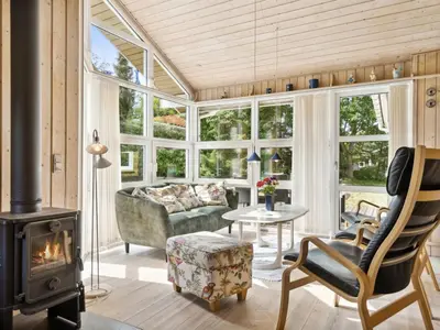 a living room with a fireplace and a couch at Holiday Home Karitte - 5km from the sea by Interhome in Fjerritslev