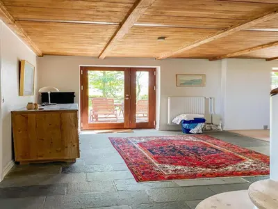 a living room with a rug and a wooden ceiling at Holiday Home Nella - 1-2km from the sea by Interhome in Fjerritslev