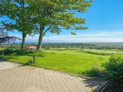 a path leading to a field with a tree at Holiday Home Nella - 1-2km from the sea by Interhome in Fjerritslev