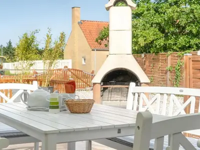a white table with two chairs and a fireplace at Holiday Home Swipdagh - 600m from the sea by Interhome in Fjerritslev