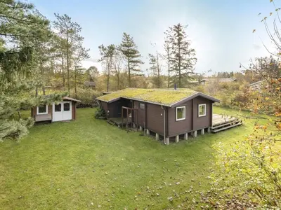 a house with a green roof and a yard at Holiday Home Artur - 1-5km from the sea by Interhome in Fjerritslev