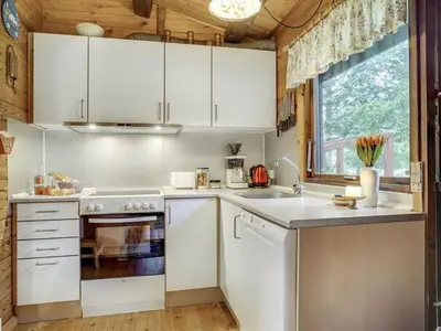 a kitchen with white appliances and a window at Holiday Home Artur - 1-5km from the sea by Interhome in Fjerritslev