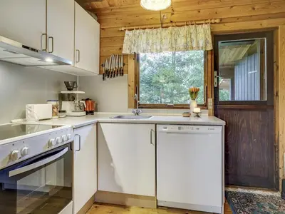 a kitchen with white cabinets and a window at Holiday Home Artur - 1-5km from the sea by Interhome in Fjerritslev