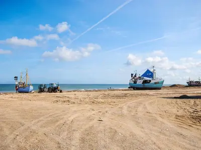 two boats sitting on the sand on a beach at Holiday Home Asmo - 350m from the sea by Interhome in Fjerritslev