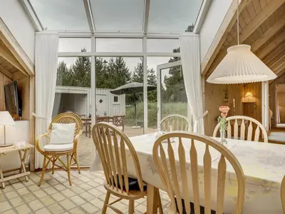 a kitchen and dining room with a table and chairs at Holiday Home Gunnie - 1-1km from the sea by Interhome in Fjerritslev