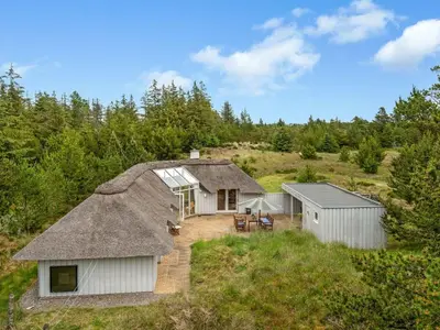 an aerial view of a cottage with a thatch roof at Holiday Home Gunnie - 1-1km from the sea by Interhome in Fjerritslev