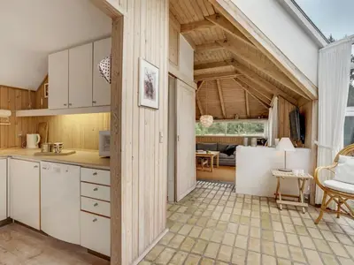 an open kitchen and living room with wooden ceilings at Holiday Home Gunnie - 1-1km from the sea by Interhome in Fjerritslev