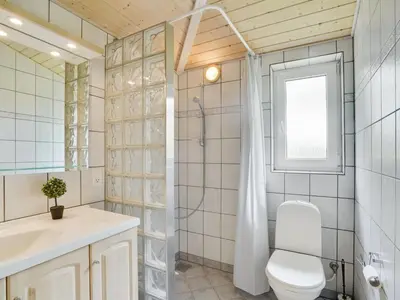 a bathroom with a toilet and a sink and a shower at Holiday Home Els - 900m from the sea by Interhome in Fjerritslev