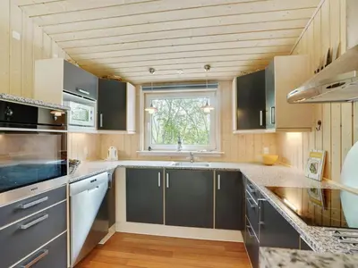a kitchen with stainless steel appliances and a window at Holiday Home Els - 900m from the sea by Interhome in Fjerritslev