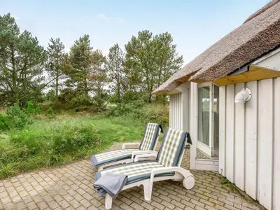 two chairs and a table on a patio at Holiday Home Catarine - 1-1km from the sea by Interhome in Fjerritslev