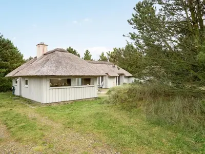 an old house with a thatched roof in a field at Holiday Home Catarine - 1-1km from the sea by Interhome in Fjerritslev