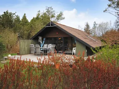 a pavilion with a table and chairs in a garden at Holiday Home Deni - 4km from the sea by Interhome in Fjerritslev