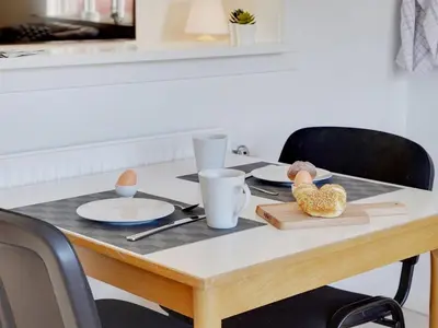 a wooden table with plates and eggs on it at Holiday Home Bitta - 500m from the sea by Interhome in Fjerritslev