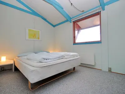 a bedroom with a bed in a room with a window at Holiday Home Momme - 500m from the sea by Interhome in Fjerritslev