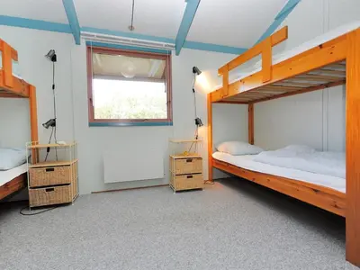 two bunk beds in a room with a window at Holiday Home Momme - 500m from the sea by Interhome in Fjerritslev