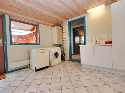 a kitchen with a washer and dryer in a room at Holiday Home Momme - 500m from the sea by Interhome in Fjerritslev