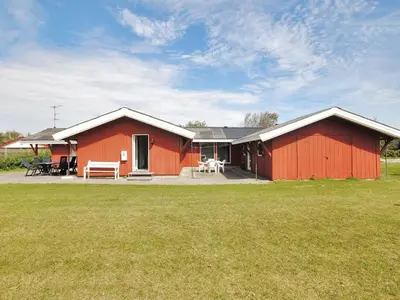 a red house with a large yard in front of it at Holiday Home Momme - 500m from the sea by Interhome in Fjerritslev