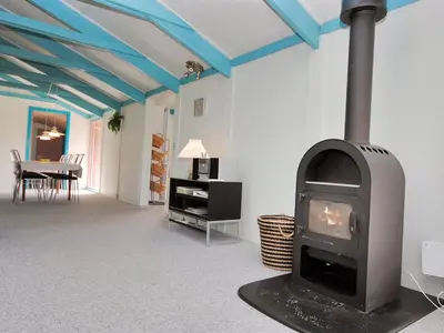 a living room with a stove in a room at Holiday Home Momme - 500m from the sea by Interhome in Fjerritslev