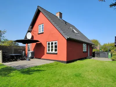 a red house with a black roof in a yard at Holiday Home Indi - 400m from the sea by Interhome in Fjerritslev