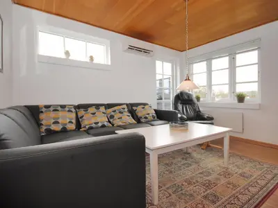 a living room with a couch and a table at Holiday Home Indi - 400m from the sea by Interhome in Fjerritslev