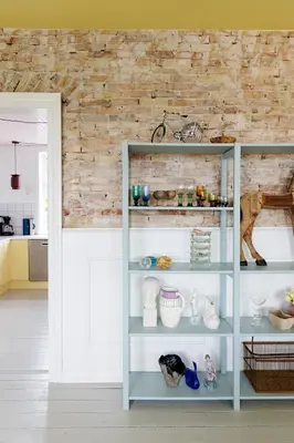 a shelf with vases and other items in a room at 18b Ferielejlighed in Harboør