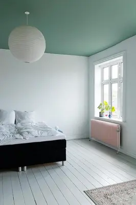 a white bedroom with a bed and a window at 18b Ferielejlighed in Harboør