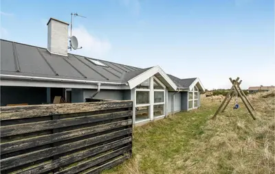 a house with a fence in front of it at Amazing Home In Thisted With Sauna in Torsted