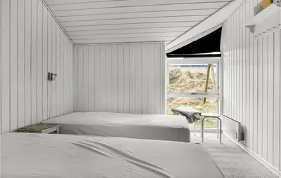 a bedroom with two beds and a window at Amazing Home In Thisted With Sauna in Torsted
