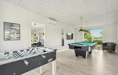 a living room with two billiard tables in it at Awesome Home In Løgstrup With Kitchen in Løgstrup