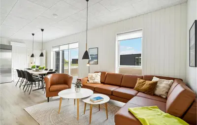 a living room with a couch and a table at Awesome Home In Løgstrup With Kitchen in Løgstrup