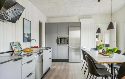 a kitchen and dining room with a table and chairs at Awesome Home In Løgstrup With Kitchen in Løgstrup