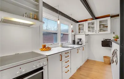 a kitchen with white cabinets and a window at Cozy Home In Vinderup With Kitchen in Vinderup
