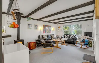 a living room with couches and a table at Cozy Home In Vinderup With Kitchen in Vinderup