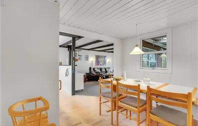 a kitchen and dining room with a table and chairs at Cozy Home In Vinderup With Kitchen in Vinderup