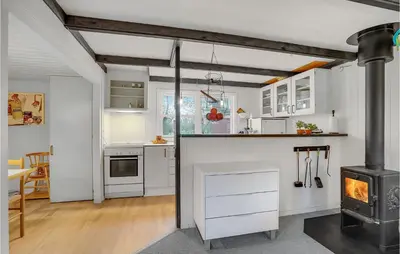 a kitchen with white cabinets and a stove at Cozy Home In Vinderup With Kitchen in Vinderup