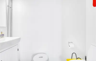 a white bathroom with a toilet and a sink at Amazing Home In Pandrup With Kitchen in Pandrup