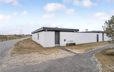 a white building on the side of a road at Amazing Home In Pandrup With Kitchen in Pandrup