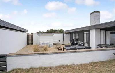 a backyard of a house with a patio at Amazing Home In Pandrup With Kitchen in Pandrup