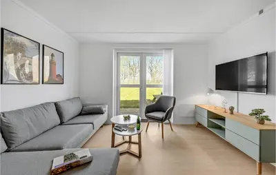 a living room with a couch and a tv at Cozy Home In Lemvig With Wifi in Lemvig
