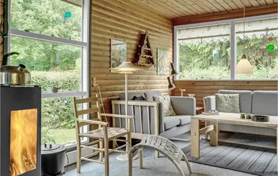 a living room with a couch and a table at Amazing Home In Nykøbing M in Hesselbjerg