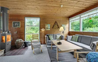 a living room with a couch and a table at Amazing Home In Nykøbing M in Hesselbjerg