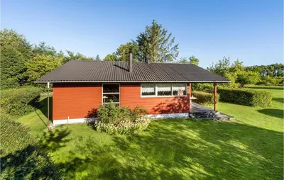 a small orange house with a black roof at Amazing Home In Nykøbing M in Hesselbjerg