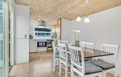 a kitchen and dining room with a table and chairs at Beautiful Home In Hanstholm With Wifi in Hanstholm