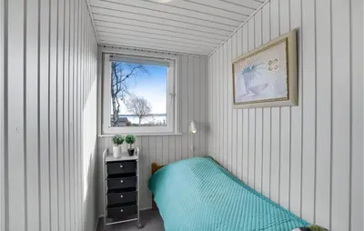 a small room with a bed and a window at Stunning Home In Roslev With Kitchen in Roslev