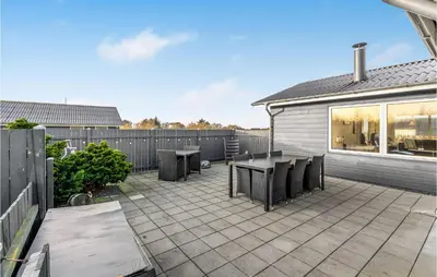 a patio with tables and chairs and a fence at Amazing Home In Vinderup With Wifi in Vinderup