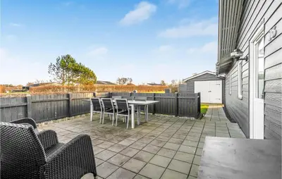 a patio with a table and chairs and a fence at Amazing Home In Vinderup With Wifi in Vinderup