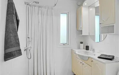 a white bathroom with a shower and a sink at Amazing Home In Vinderup With Wifi in Vinderup